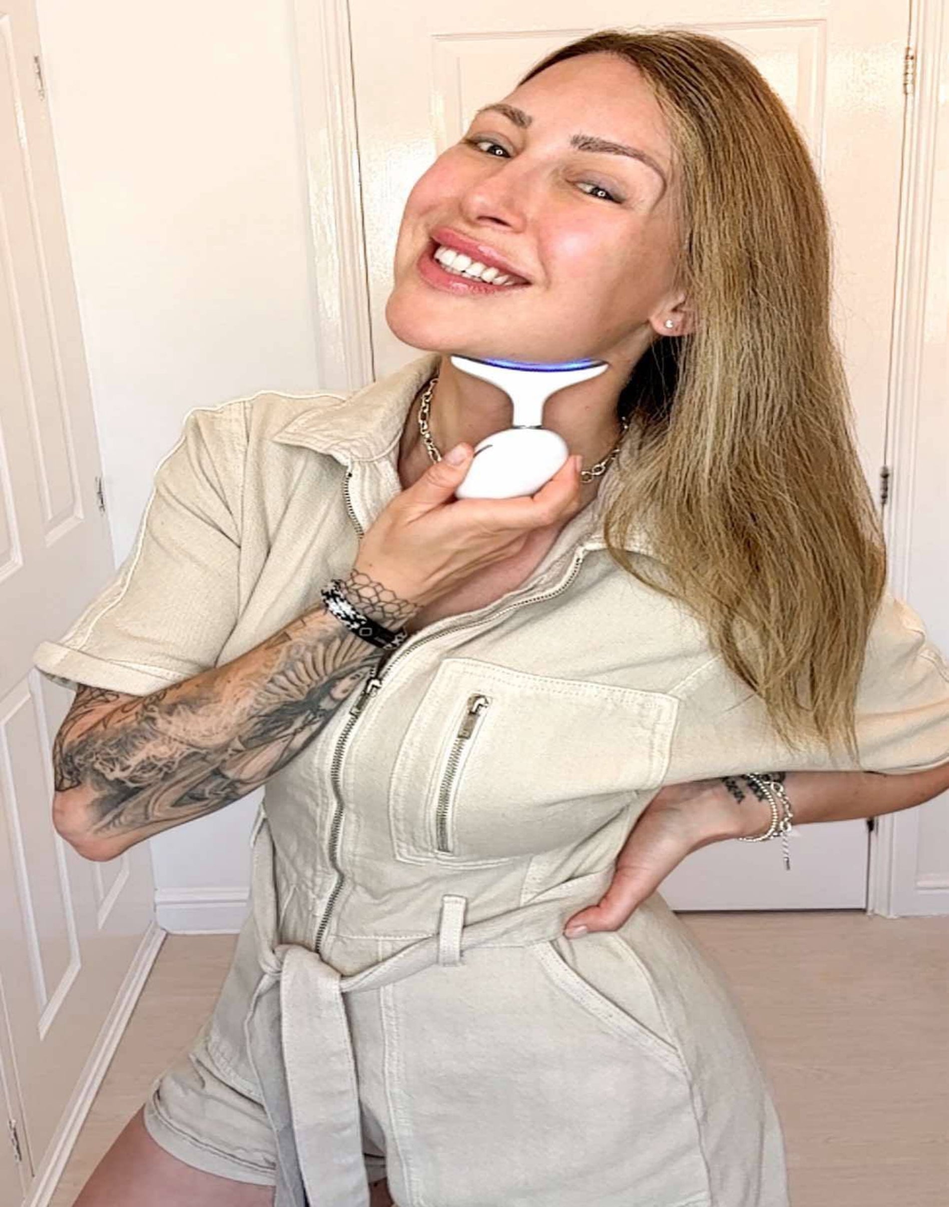 LED Glow Massager showing direction of use - up from the base of the neck to the chin