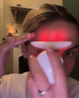 LED Glow Massager showing direction of use, from the chin to the outside of the eye up the cheekbones and from the eyebrows up the forehead