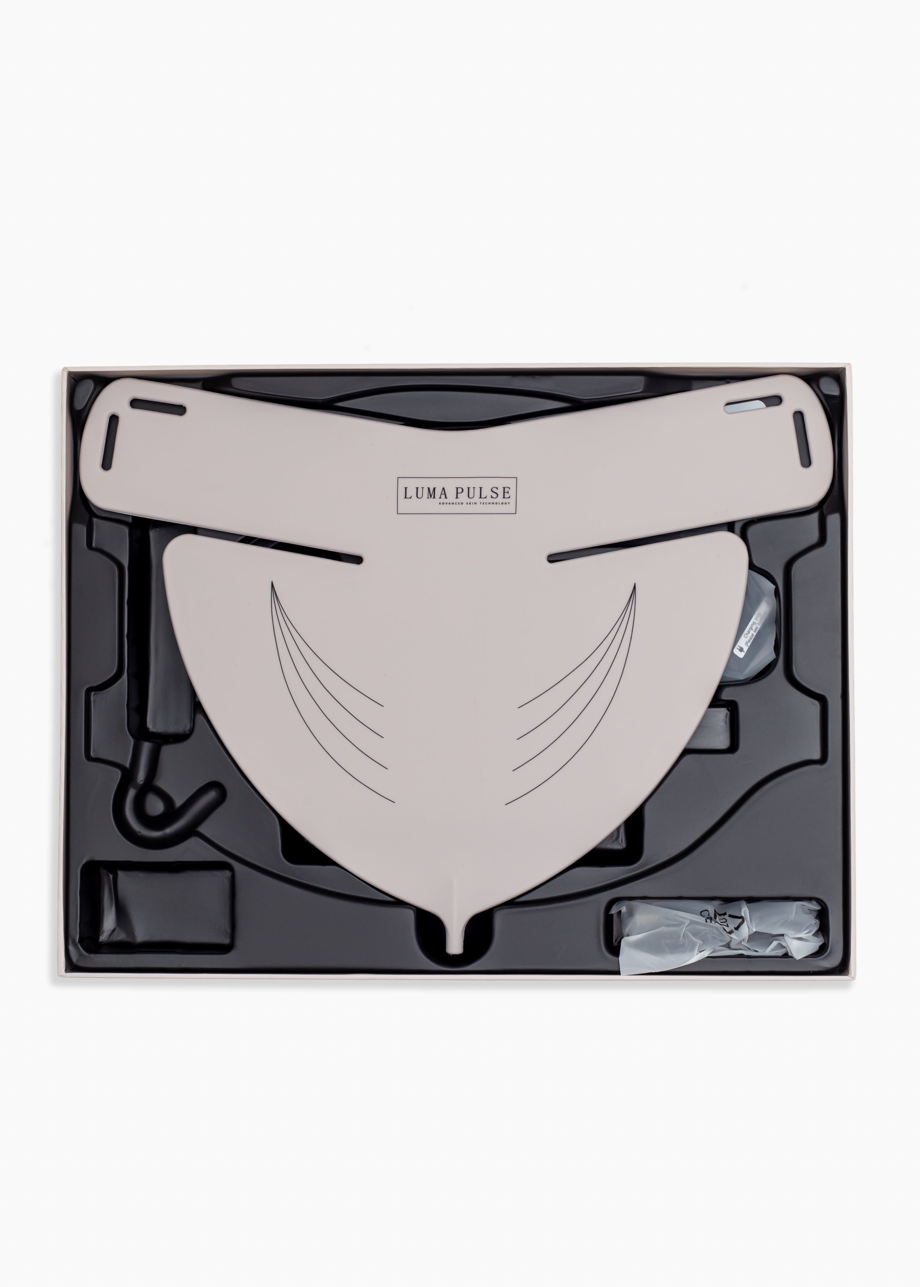 Taupe face mask in a black box with 'Luma Pulse' branding on a white background