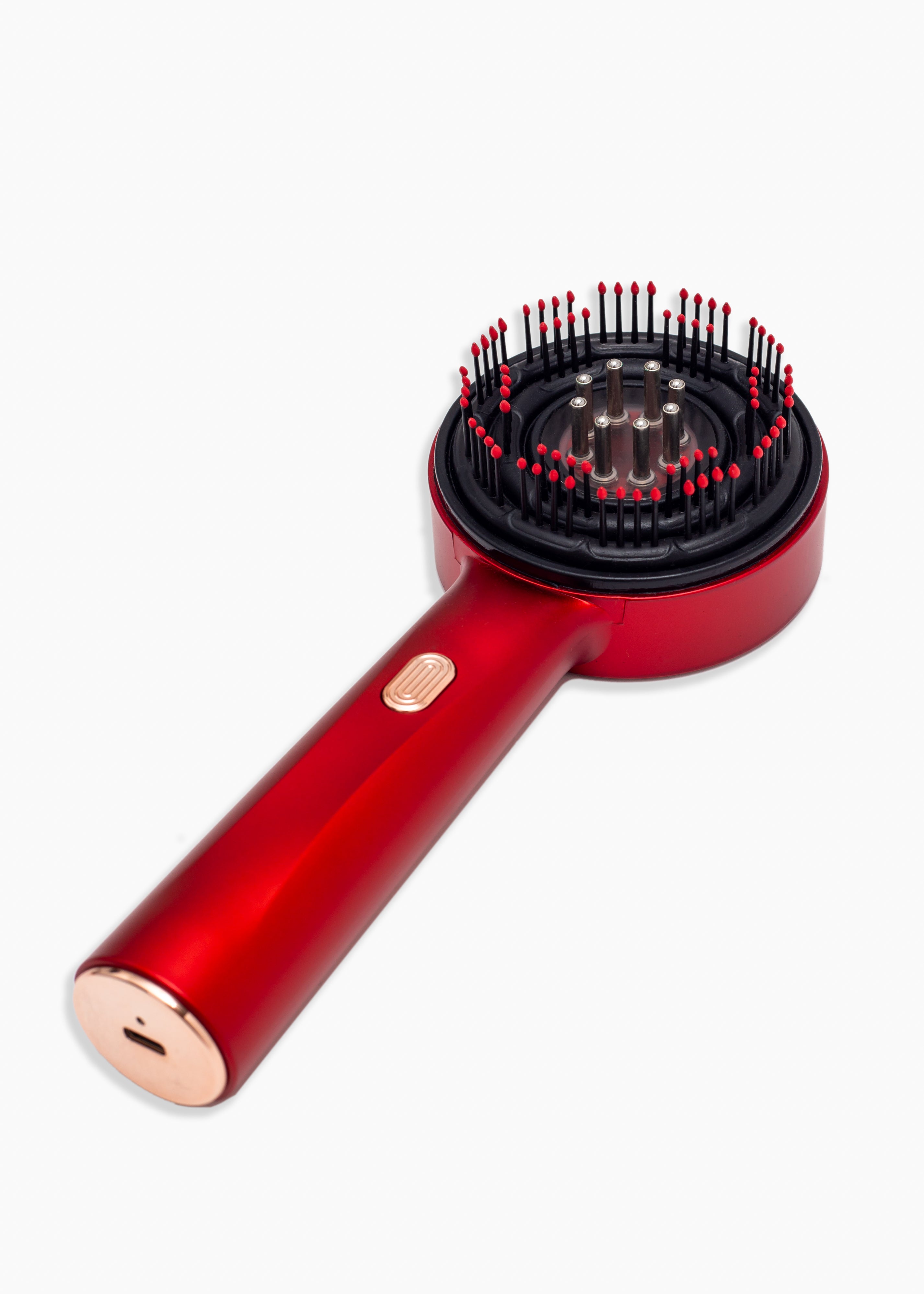 Red hairbrush with black bristle head on a white background